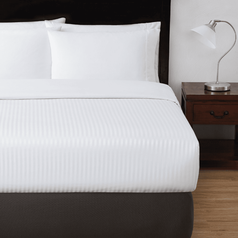 Striped decorative top sheet for hotels, Airbnb, and resort bedding—ideal for elevated room presentation and guest comfort