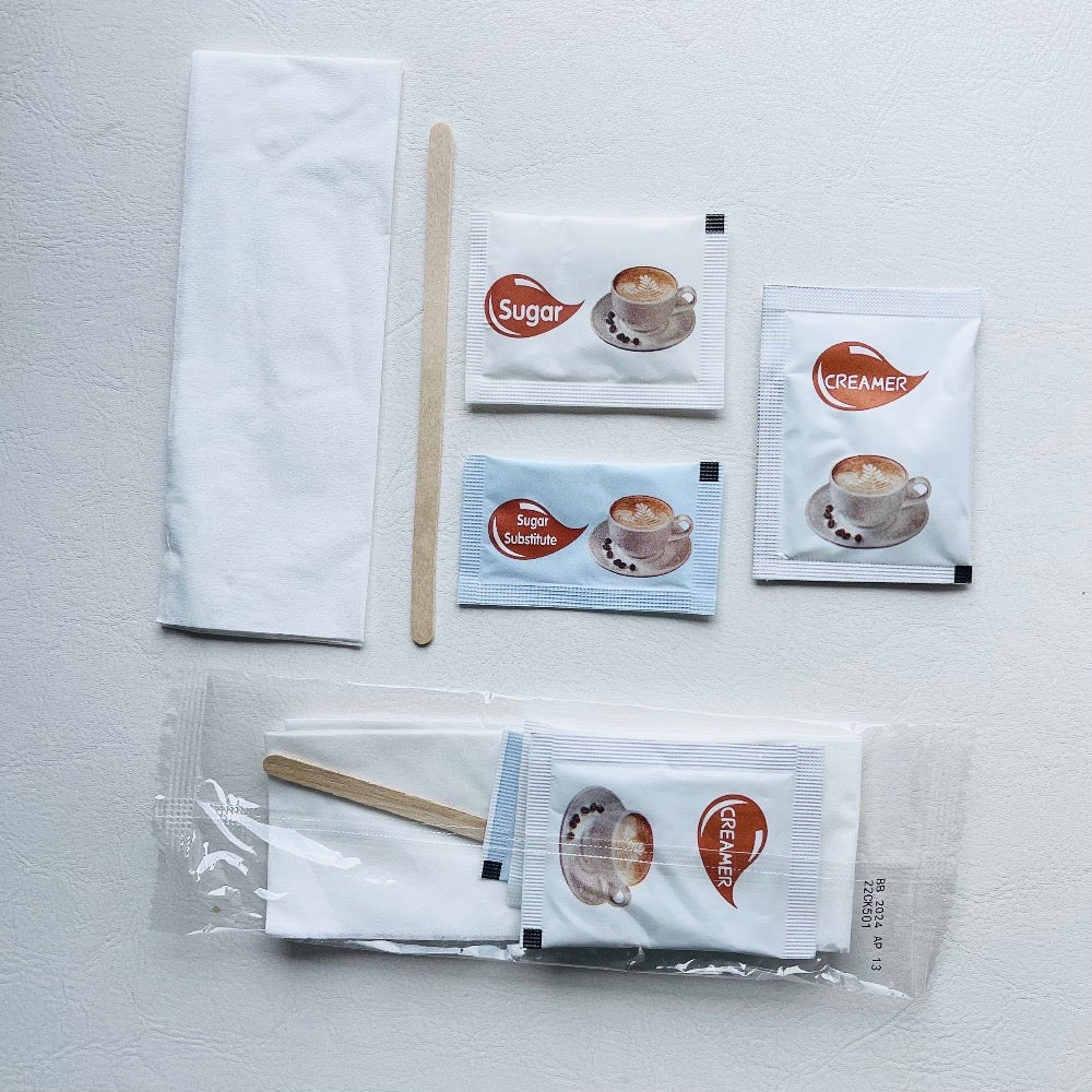 Clear condiment kit - 1 sugar, 1 sugar substitute, 1 creamer, 1 stir stick and 1 napkin at Canadian Hotel Supplies