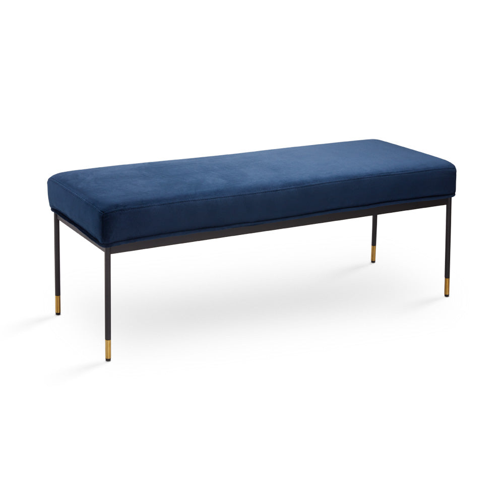 Modern Roger blue velvet bench with slim black metal legs and gold tips, ideal for hotel rooms, entryways, or bedroom seating in contemporary spaces.