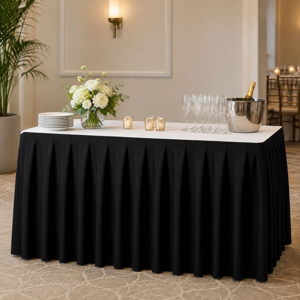 Black pleated banquet table skirt for hotels, banquet halls, catering services and event venues, displayed on a professionally arranged service table.