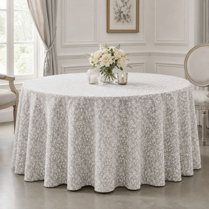 White and grey damask round tablecloth for hotels, banquet halls, restaurants and event venues, shown in an upscale table setting.