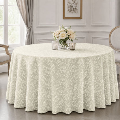 Ivory patterned round tablecloth for hotels, banquet halls, restaurants and event venues, styled on a formal round dining table.