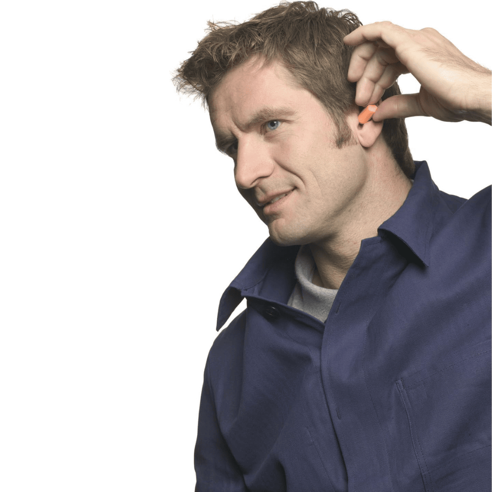 A man putting the 3M 1100 Foam Ear Plug in his ear