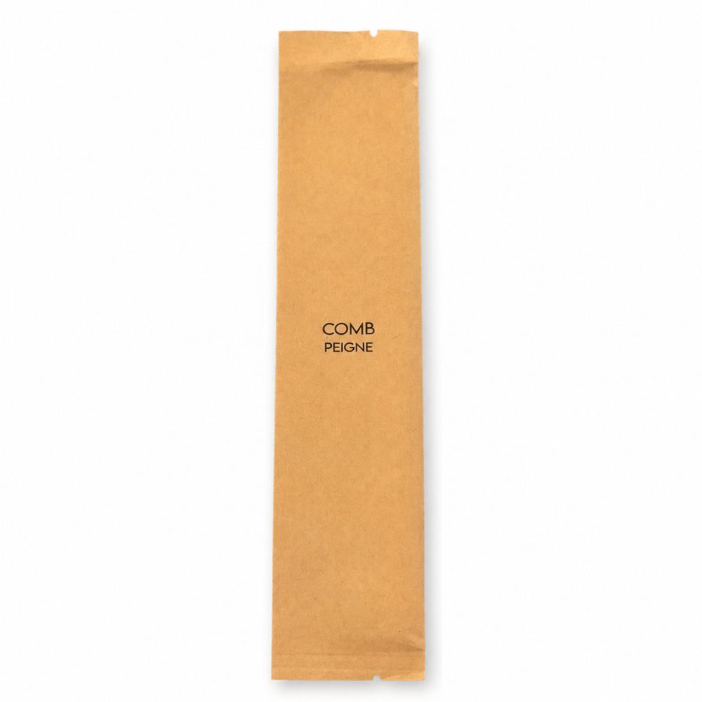 Individually wrapped white comb in a kraft sleeve labelled Comb and Peigne, designed for hotels, resorts, spas and guest amenities.