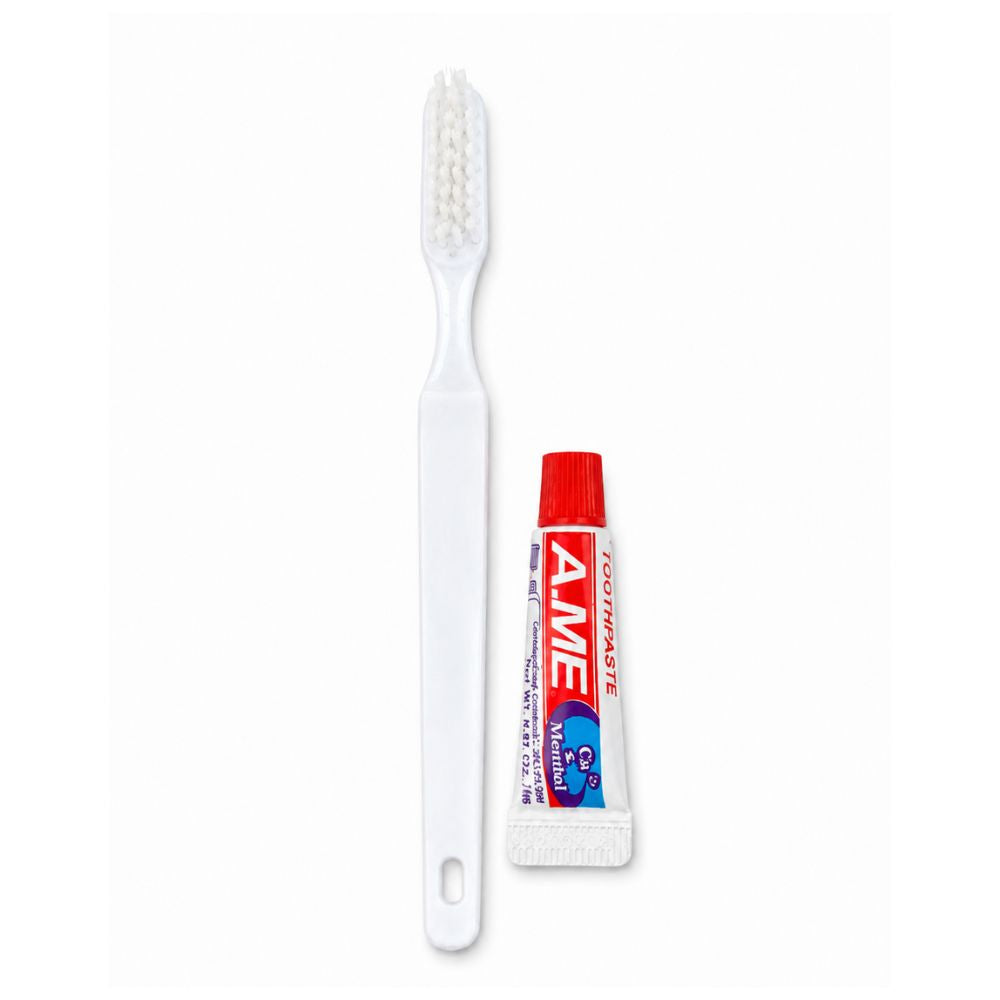 White toothbrush and travel-size mint toothpaste on a clean background, suitable for hotel rooms, guest kits and bulk hospitality use.