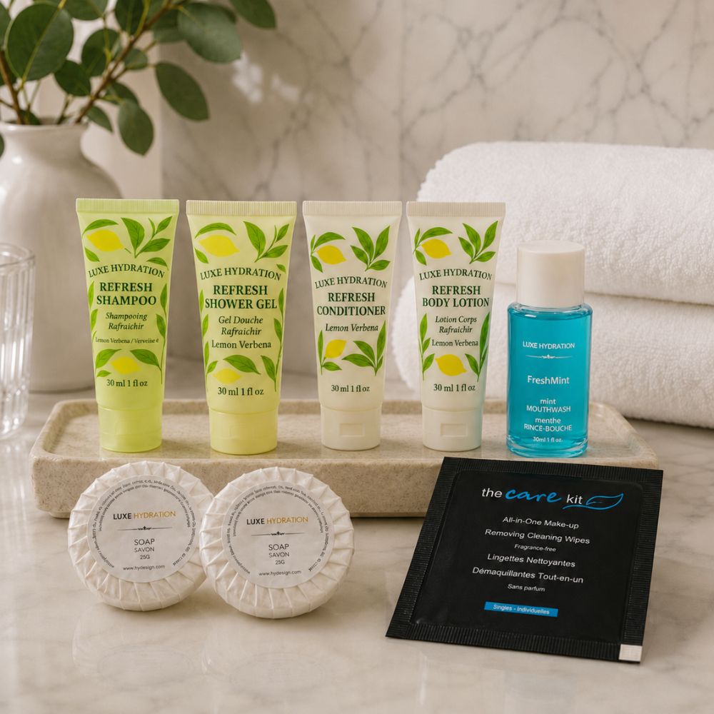 Lemon Verbena hotel amenities displayed in a guest bathroom with two soaps, FreshMint mouthwash and makeup remover wipe.