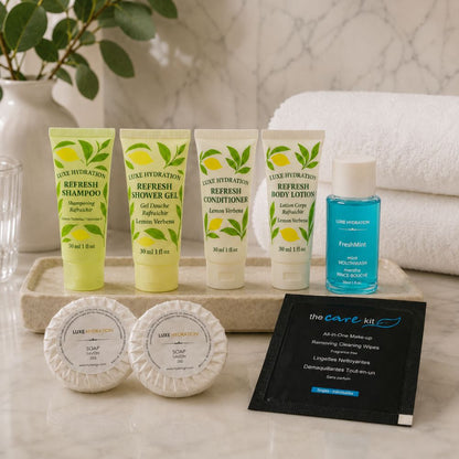 Lemon Verbena hotel amenities displayed in a guest bathroom with two soaps, FreshMint mouthwash and makeup remover wipe.
