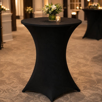 Black fitted spandex cocktail table cover styled in an upscale event venue, ideal for hotels, banquet halls, receptions and corporate events.