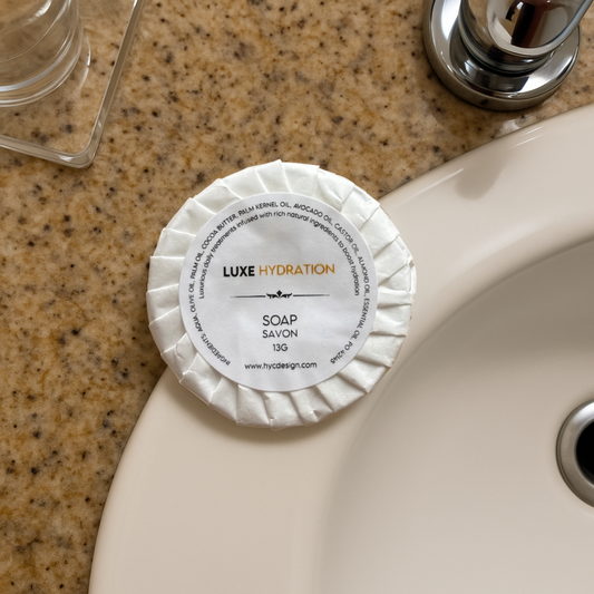  Luxe Hydration Soap 13g on hotel sink, a compact and elegant addition to guest bathroom essentials.