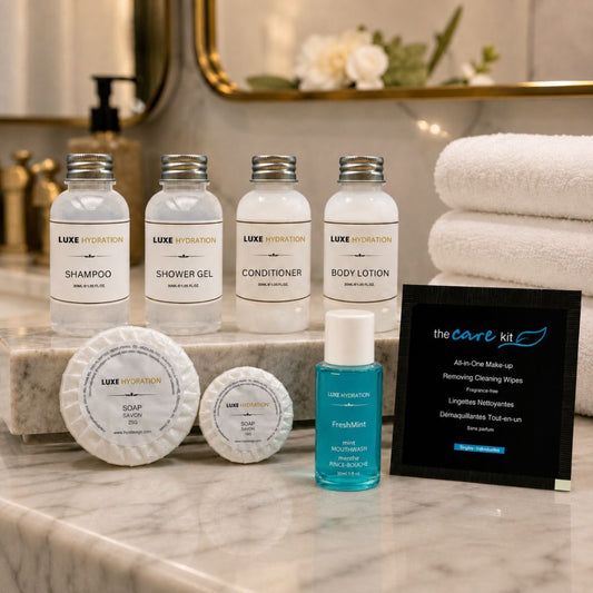 Luxe Hydration hotel amenity display with toiletries, two soap sizes, FreshMint mouthwash and makeup wipe for guest-room programs.