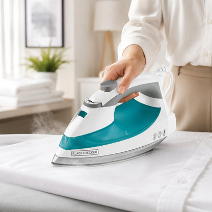 Hotel housekeeping steam iron being used on white linens for professional guest room bedding and hospitality laundry care.
