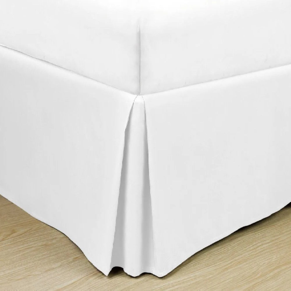 Soft microfiber bed skirt in solid color, designed for hotels and Airbnb guest beds to conceal bases and elevate room aesthetics